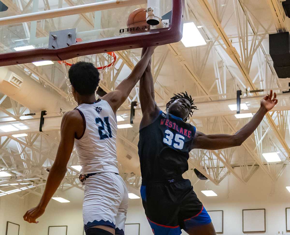 Westlake center Wonder Kahozi (35) blocks a dunk attempt by Fort Bend Clements Rangers' Rahman Olajuwon (21) during the William Roberts Memorial Tournament on Dec 30.
